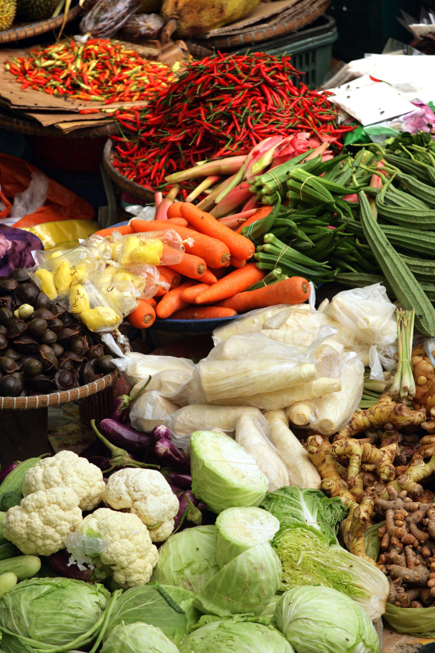 Muslim woman selling fresh vegetables at market in Kota Bharu Mal