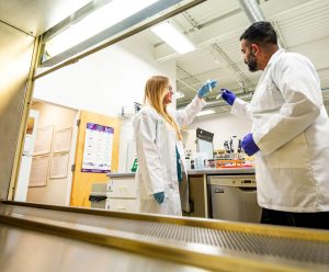 Two scientists in lab holding viles